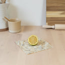 one small square beeswax foodwrap, made with beeswax, tree resin, and organic jojoba oil infused into a hemp and organic cotton cloth.