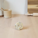 one small square beeswax foodwrap, made with beeswax, tree resin, and organic jojoba oil infused into a hemp and organic cotton cloth.